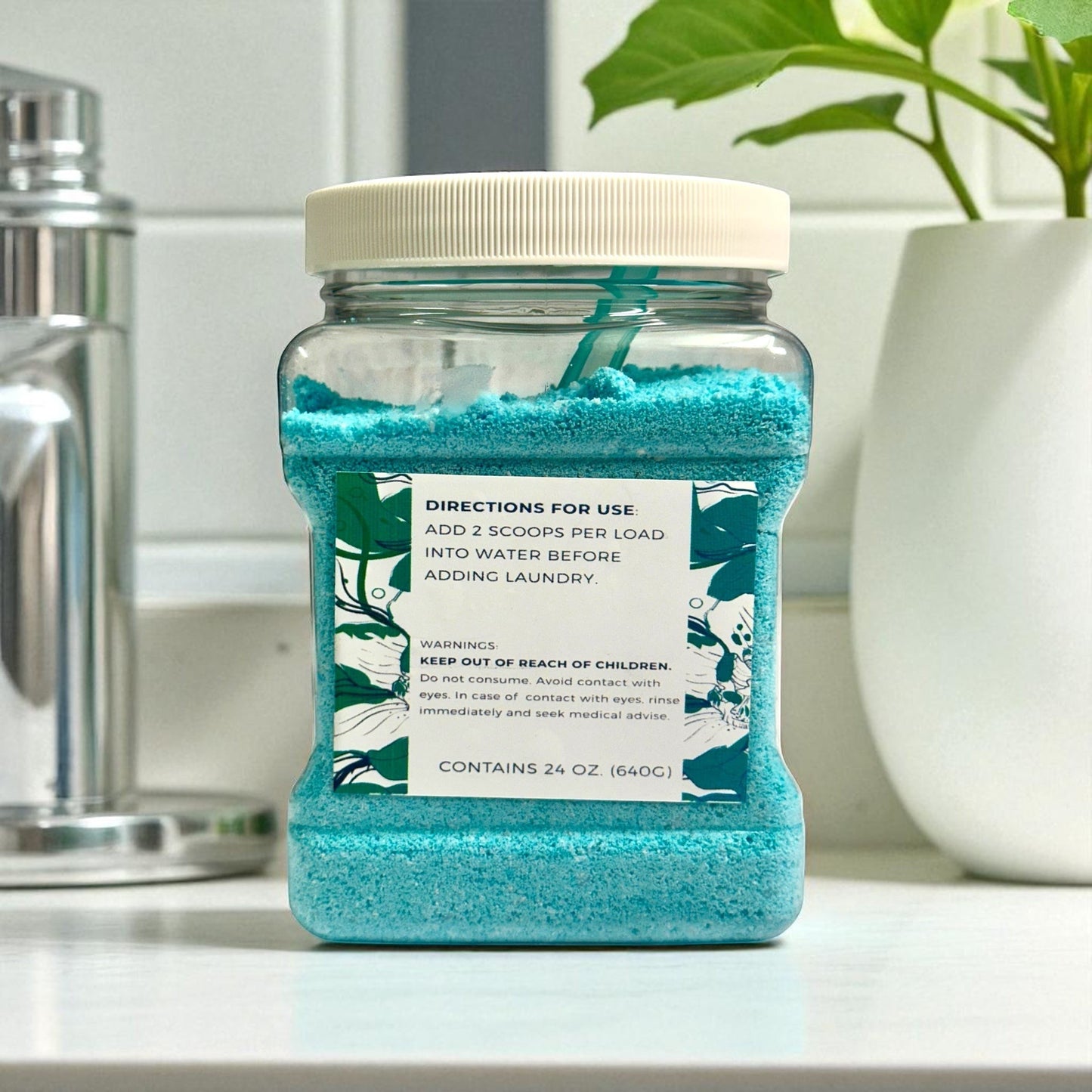 Doodlations Luxury Laundry Soap Bum Bum, a blue granular detergent in a clear plastic jar with a white lid.