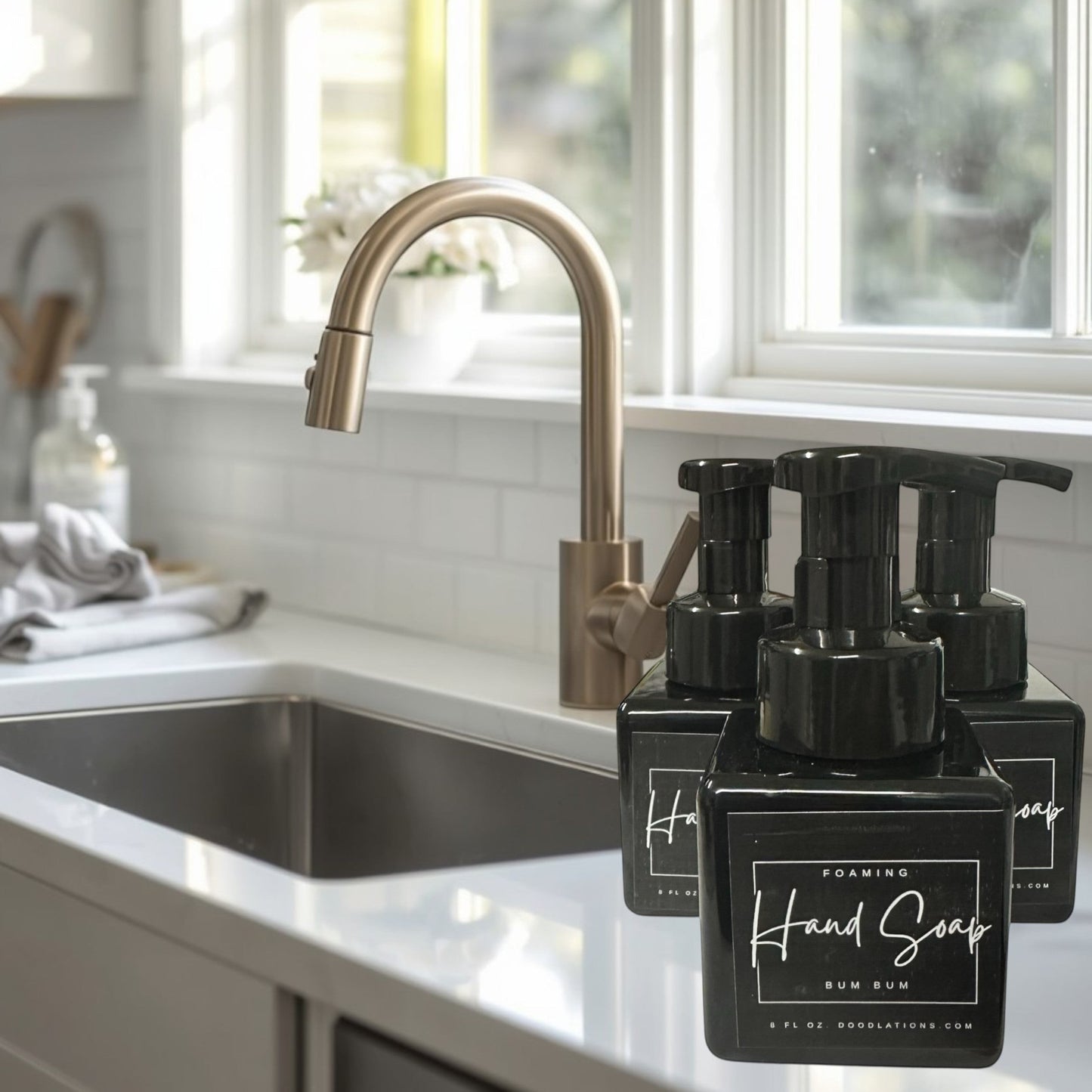 Doodlations Bum Bum foaming hand soap in a black bottle with a tropical floral background.