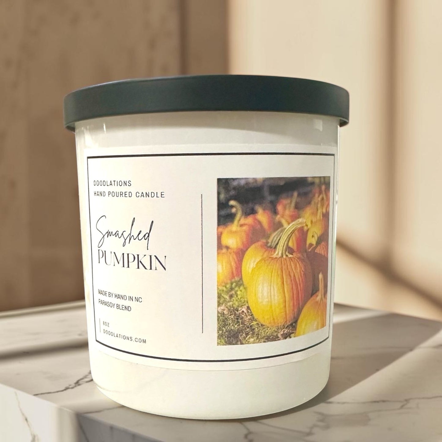 Doodlations Coffee Bar & Boutique Smashed Pumpkin hand-poured soy blend candle with a dark green lid.