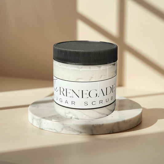 The Renegade Men's Sugar Scrub in a clear jar with a black lid. White textured scrub inside.