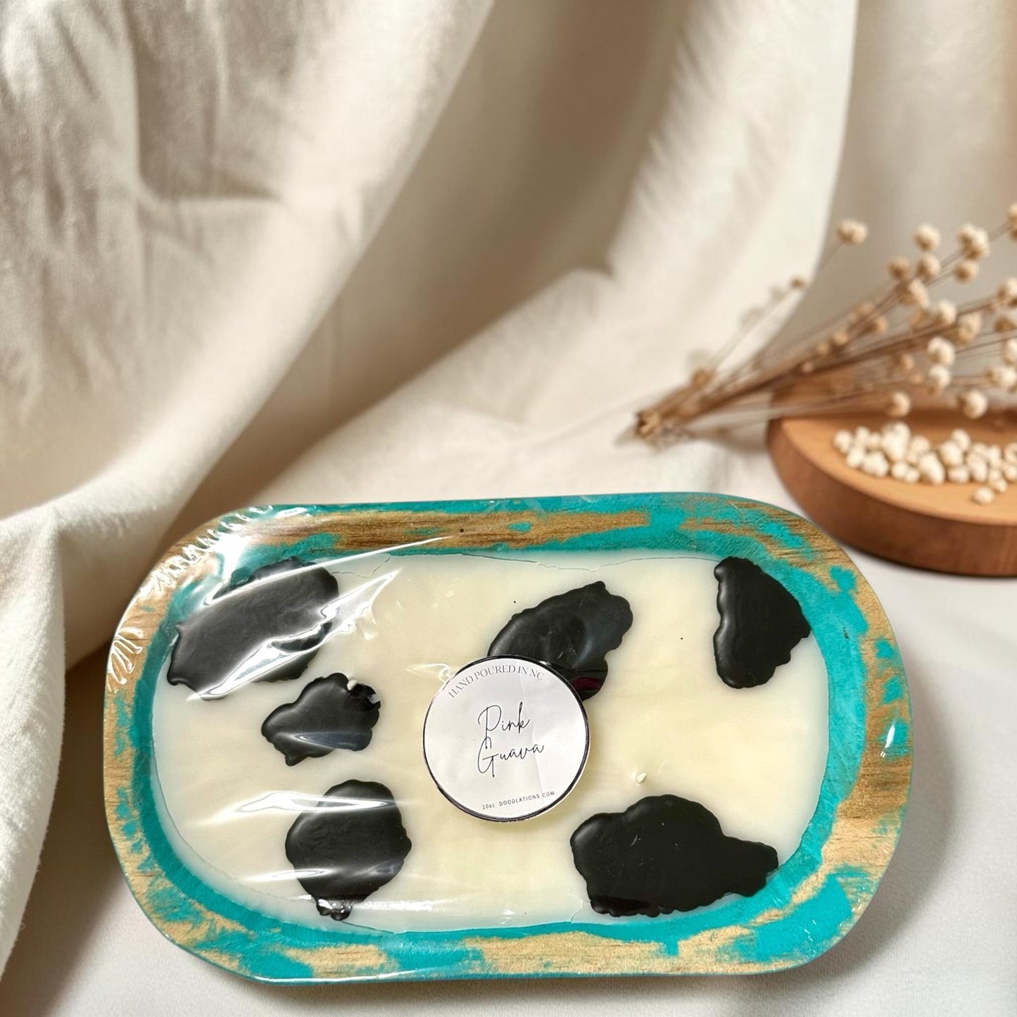 cow dough bowl candle in pink guava scent, with black cow spots.