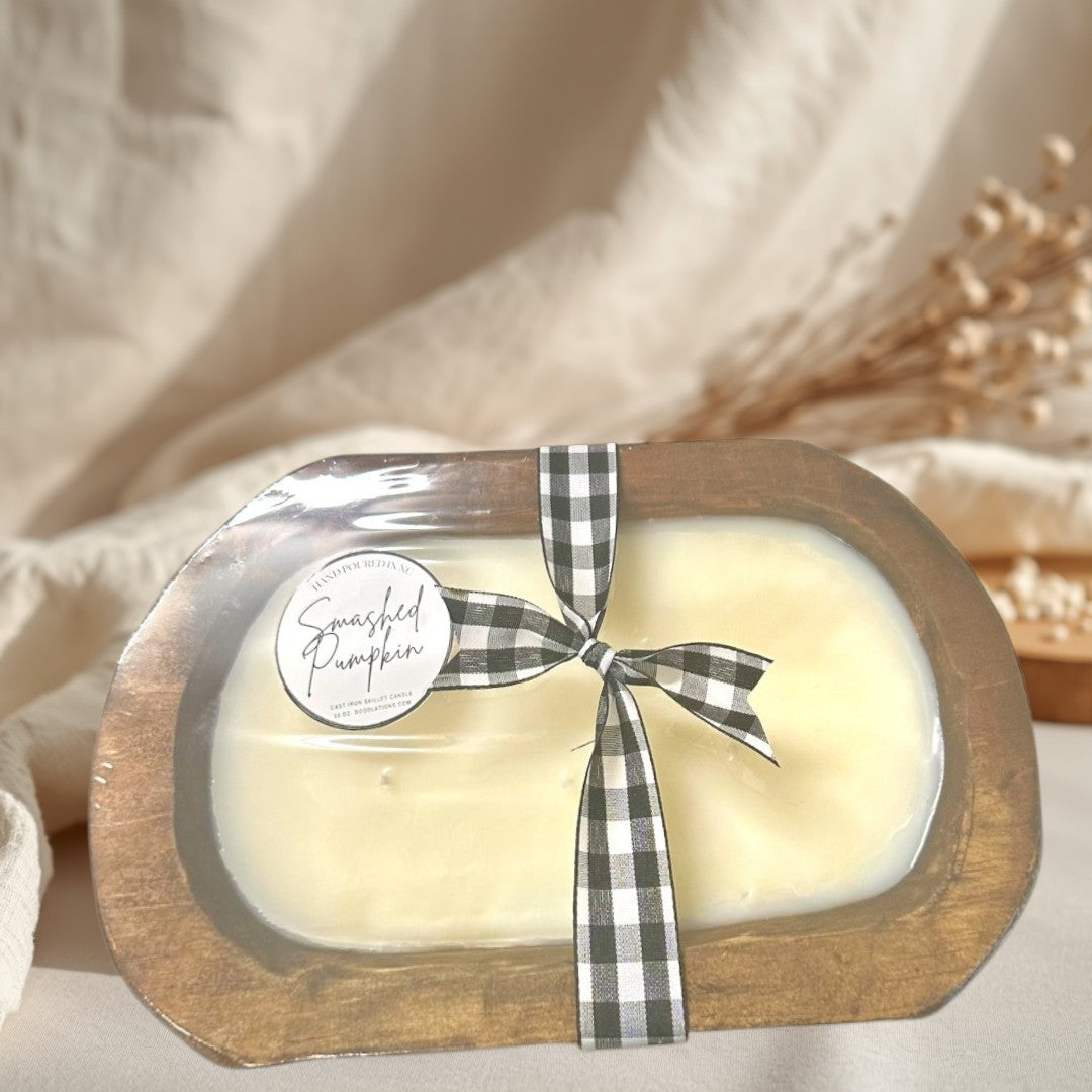 wooden dough bowl candle with black and white buffalo check ribbon.