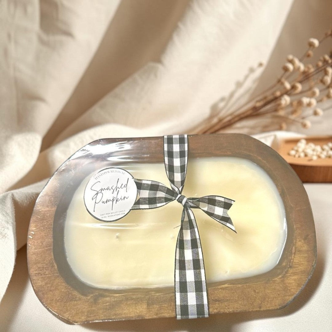 wooden dough bowl candle with black and white buffalo check ribbon.