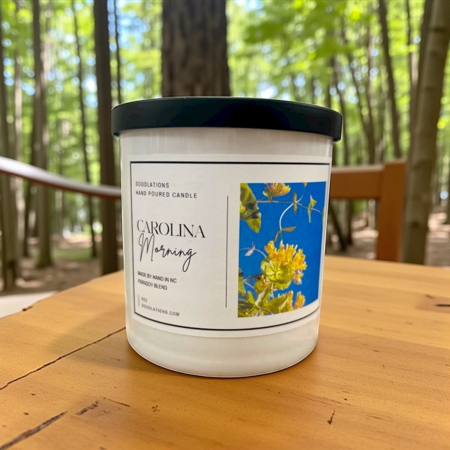 Doodlations Coffee Bar & Boutique Carolina Morning hand-poured soy blend candle with floral label.