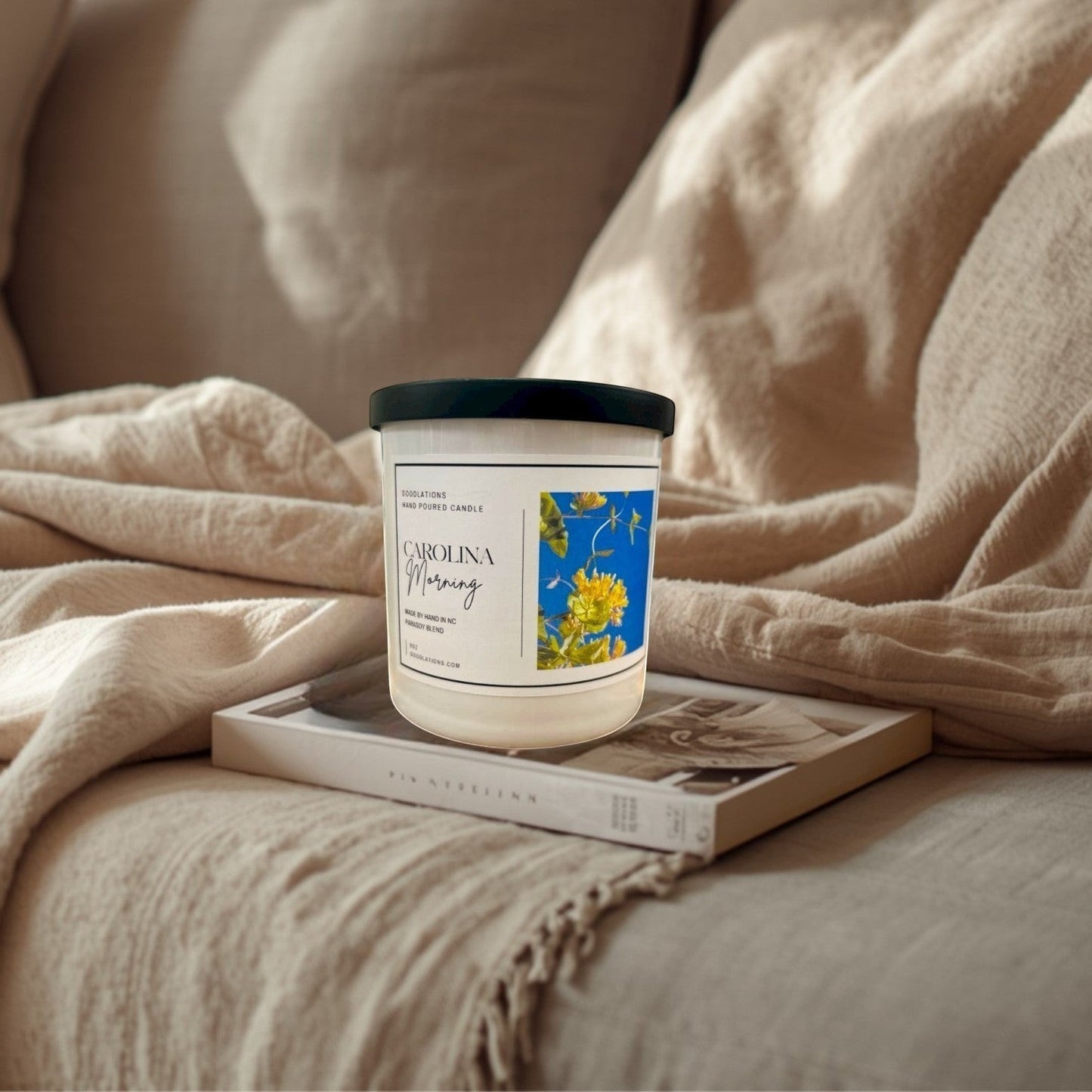 Doodlations Coffee Bar & Boutique Carolina Morning hand-poured soy blend candle with floral label.