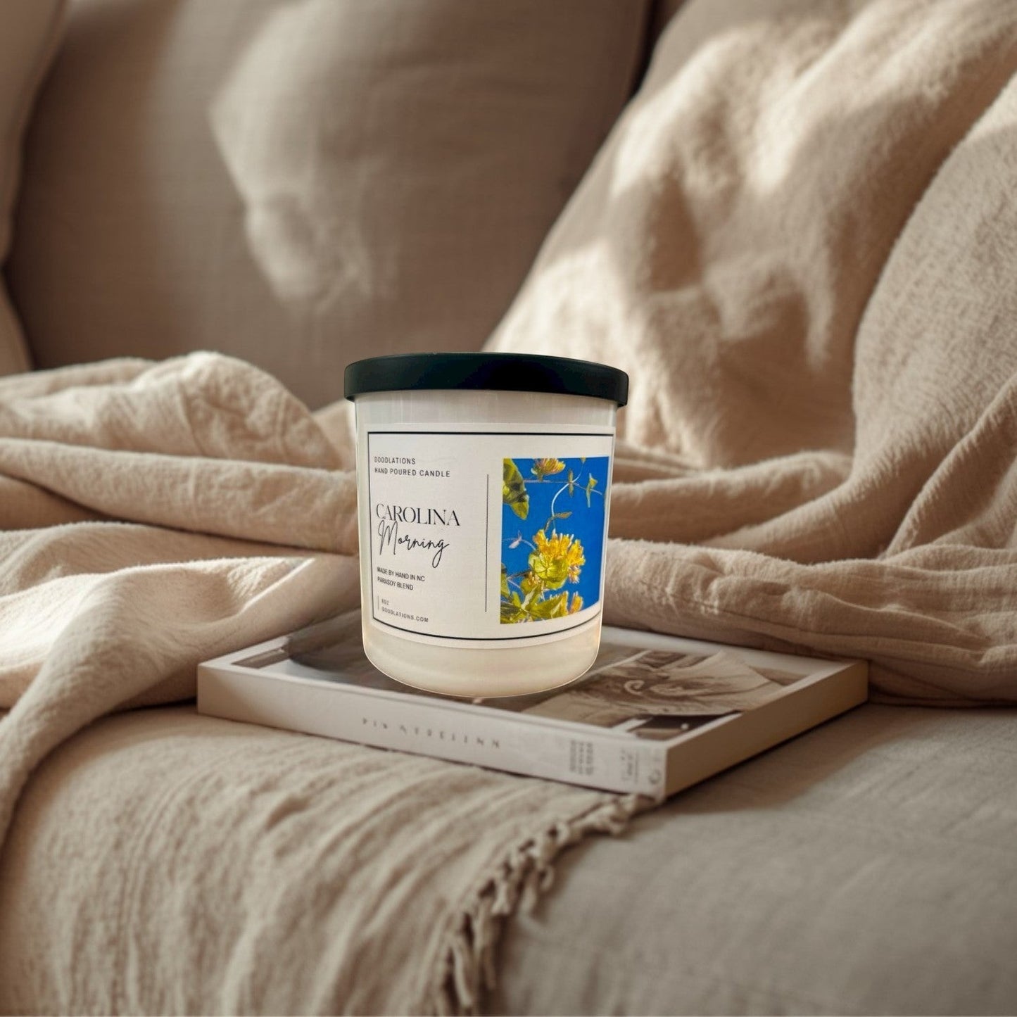Doodlations Coffee Bar & Boutique Carolina Morning hand-poured soy blend candle with floral label.