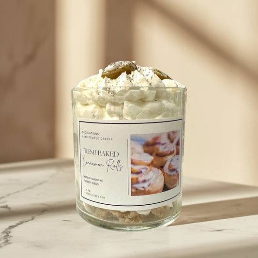 Doodlations Coffee Bar & Boutique Cinnamon Bun candle with decorative wax toppings resembling cinnamon rolls and whipped cream.