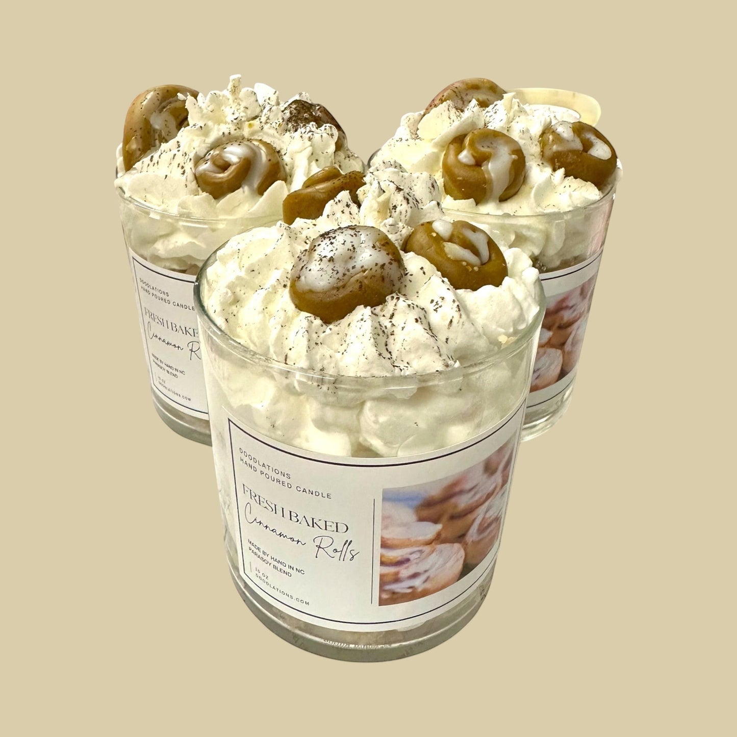 Cinnamon Bun candle with decorative wax toppings resembling cinnamon rolls and whipped cream.