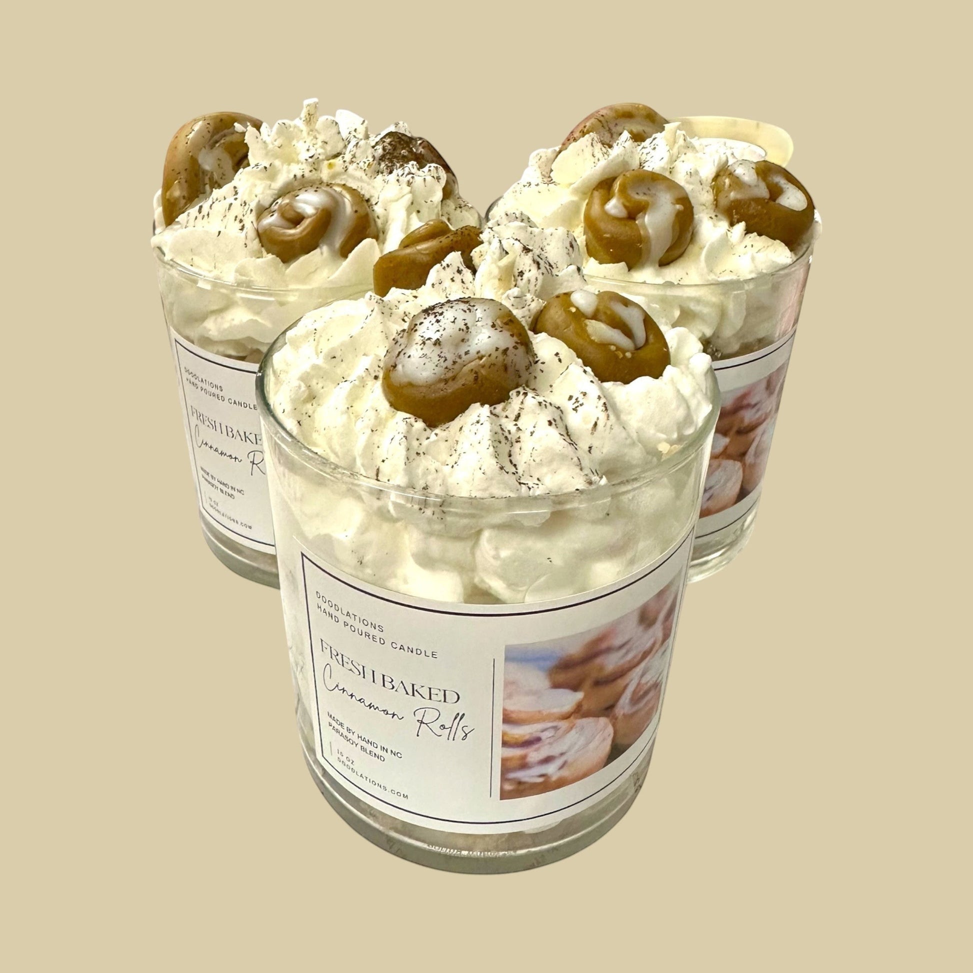Cinnamon Bun candle with decorative wax toppings resembling cinnamon rolls and whipped cream.