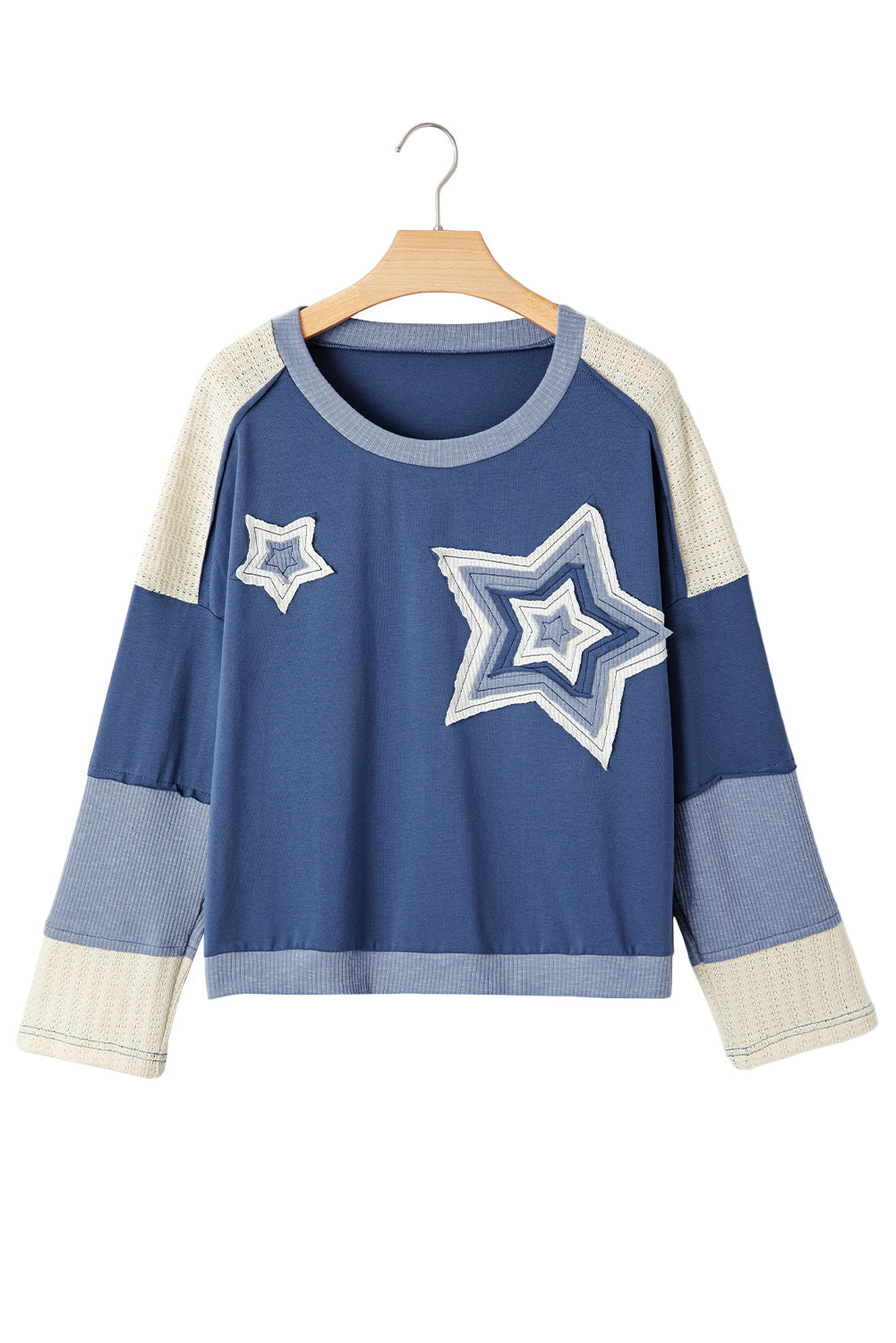 Blue sweater with star designs on a hanger against a white background