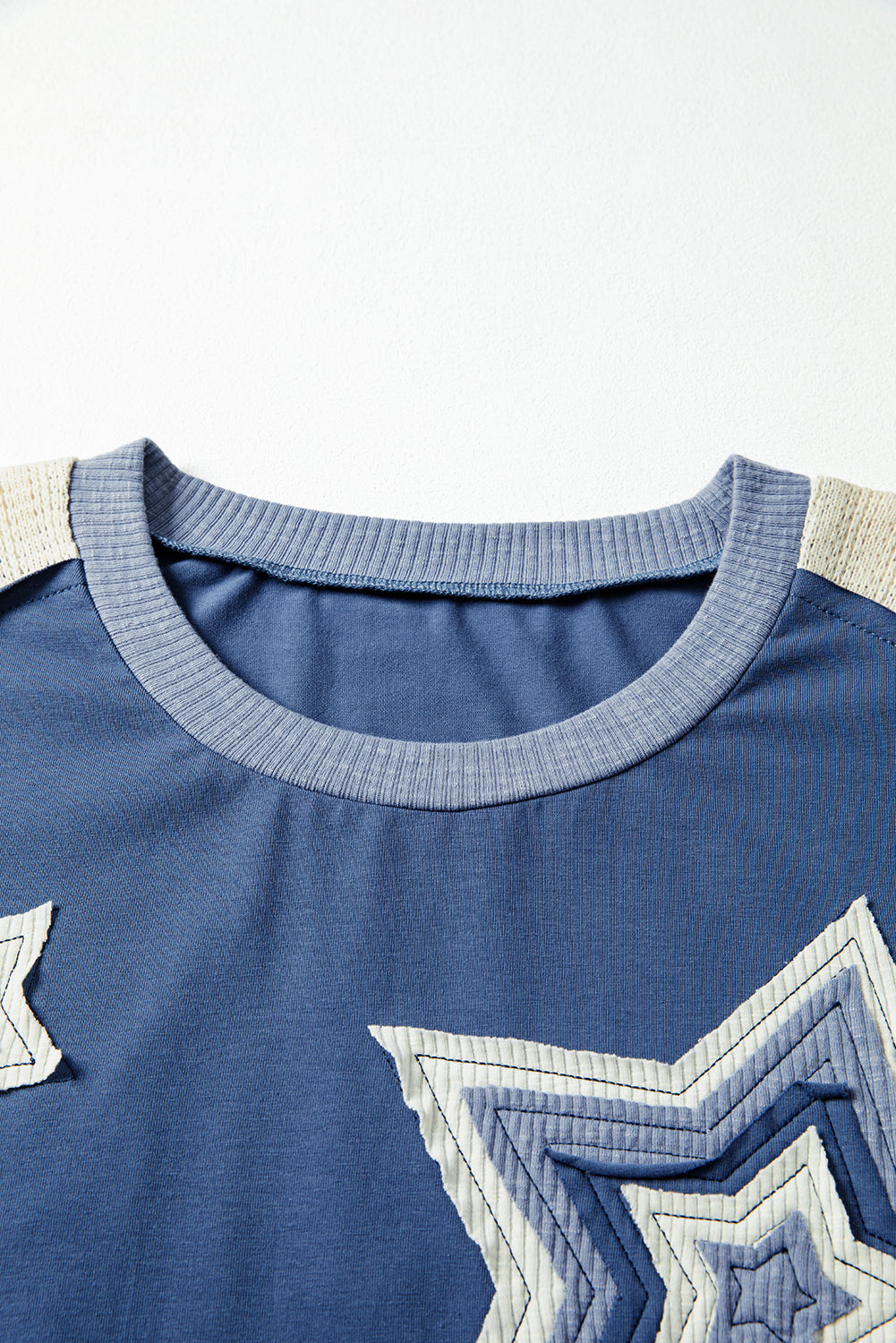 Blue shirt with star designs on a white background