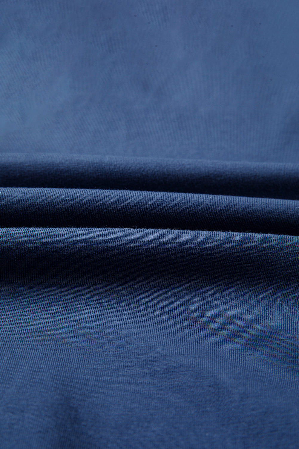 Close-up of blue fabric with folds