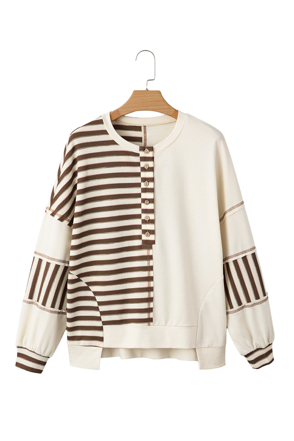 Beige sweater with brown stripes on a wooden hanger against a white background