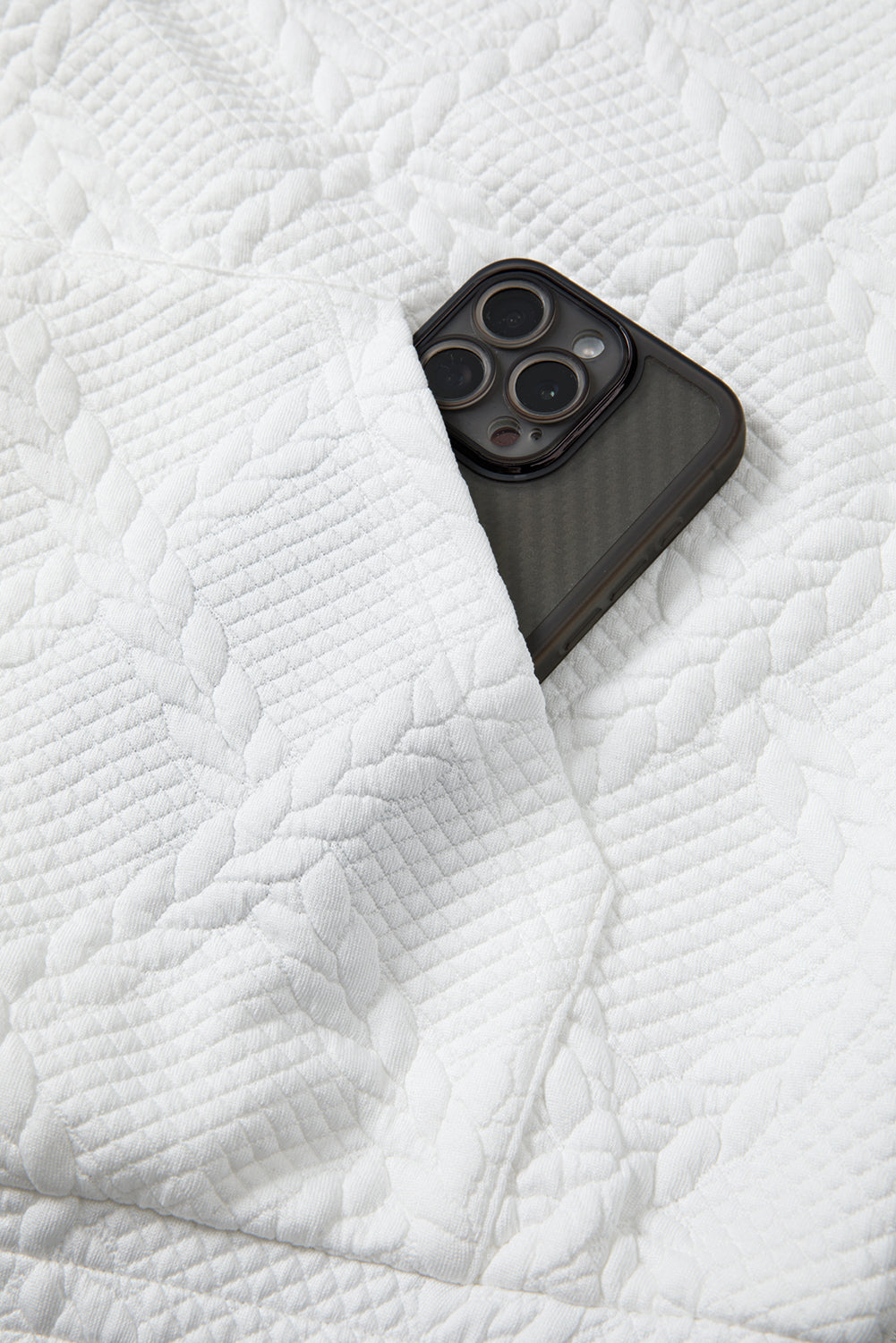 Black phone case on a white textured surface