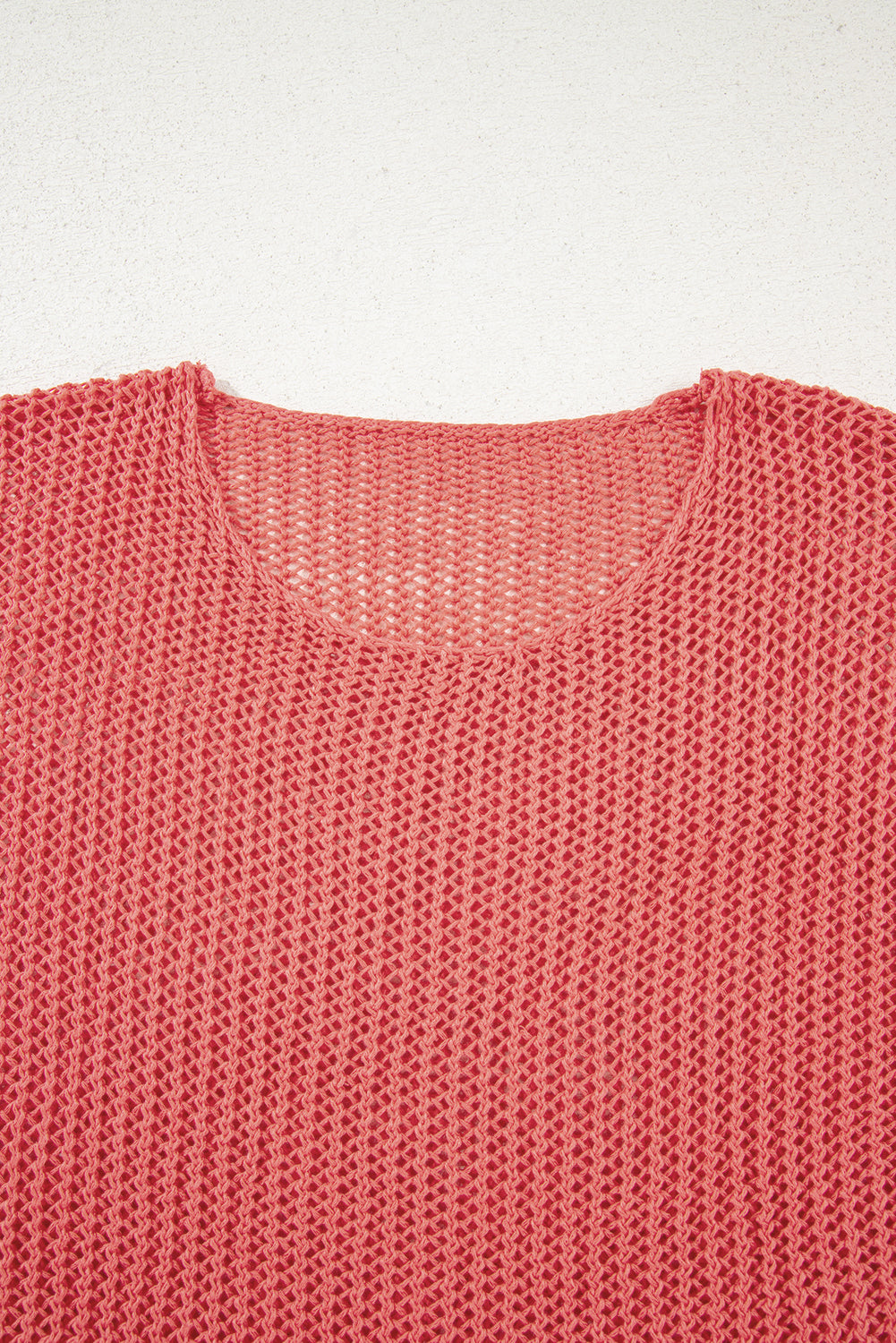 Close-up of a pink knitted garment on a white background