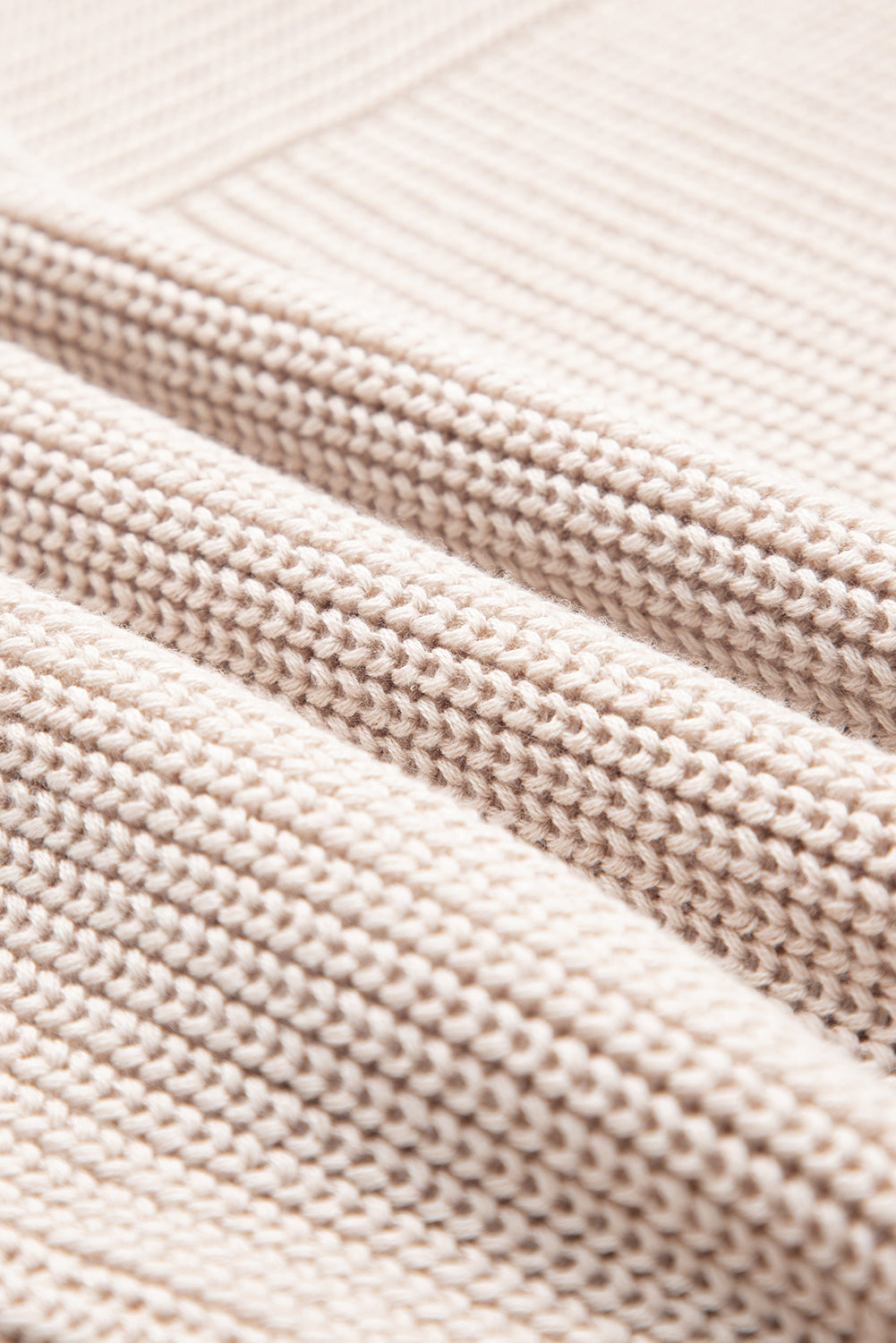 Close-up of beige fabric with a textured pattern