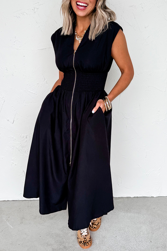 Woman wearing a black sleeveless dress with a white background