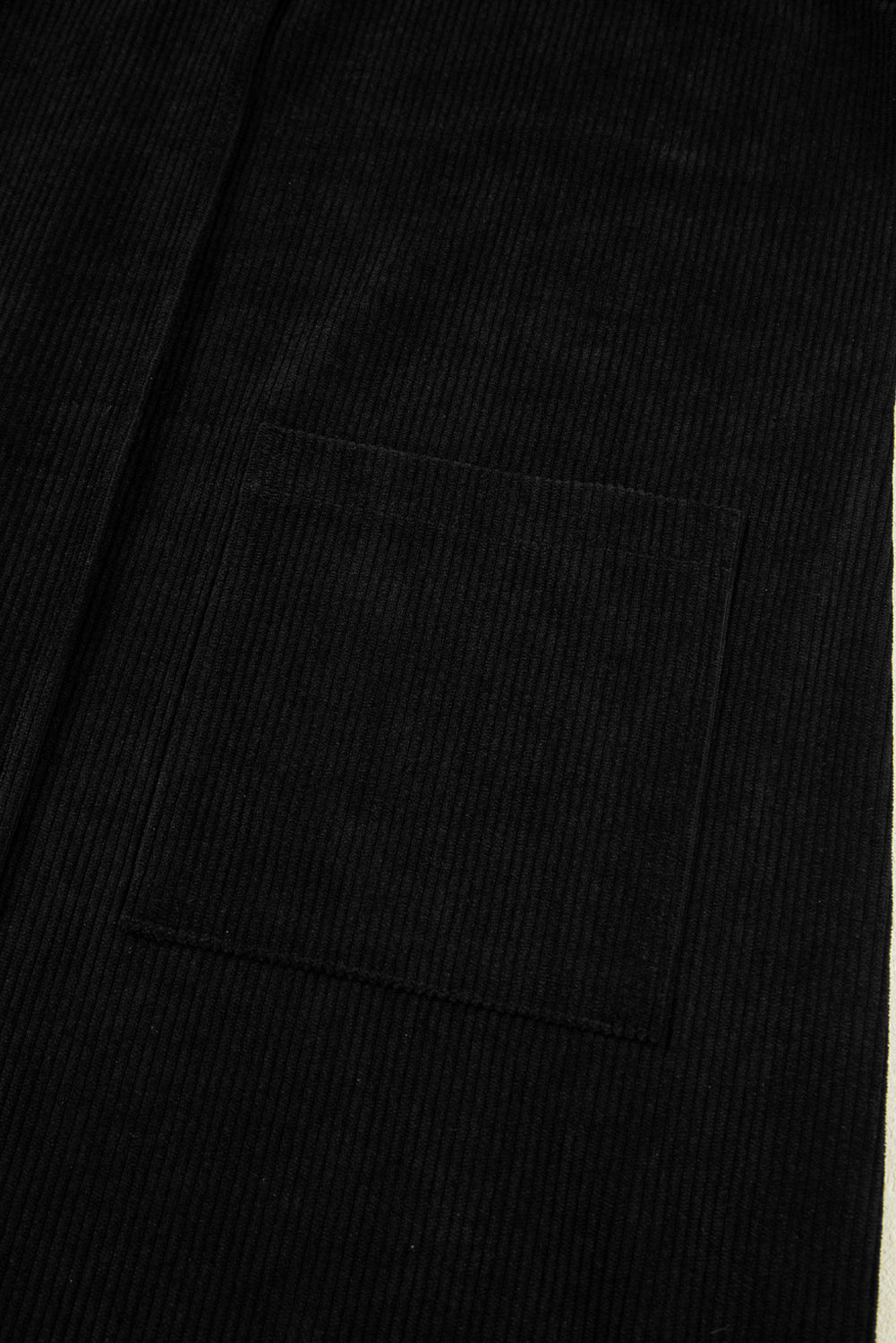 Close-up of a black suit jacket with a pocket detail