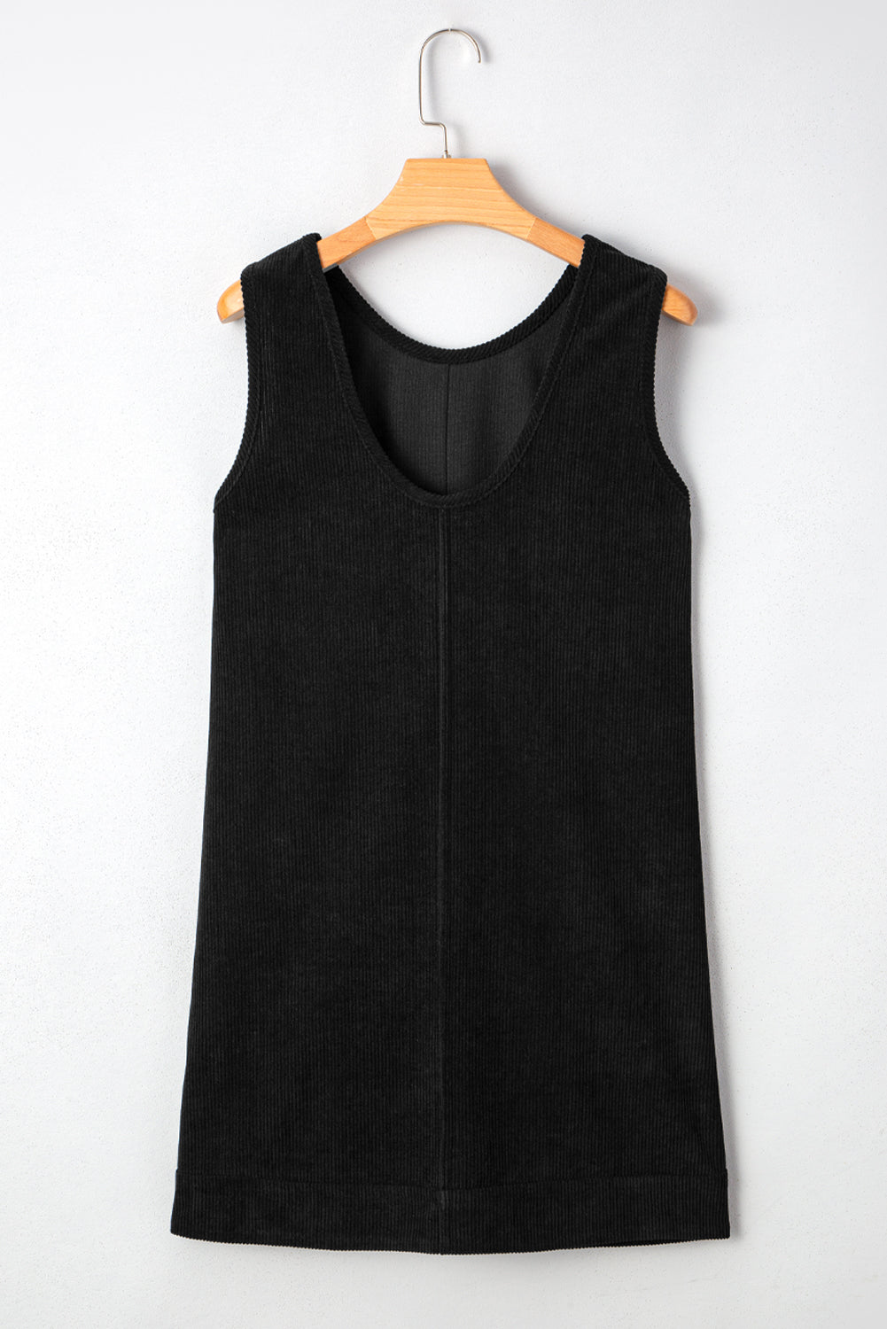 Black sleeveless dress on a wooden hanger against a white background