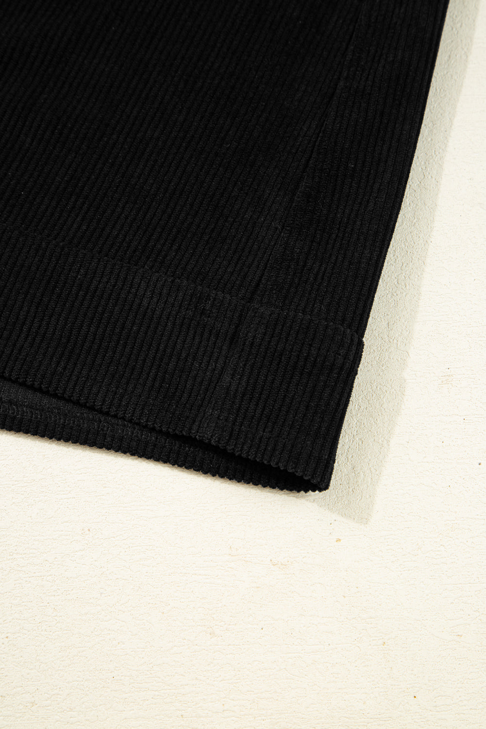 Close-up of a black fabric edge on a white background