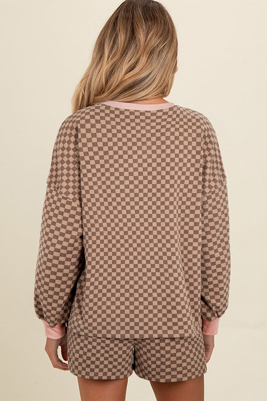 Person wearing a brown checkered outfit on a beige background