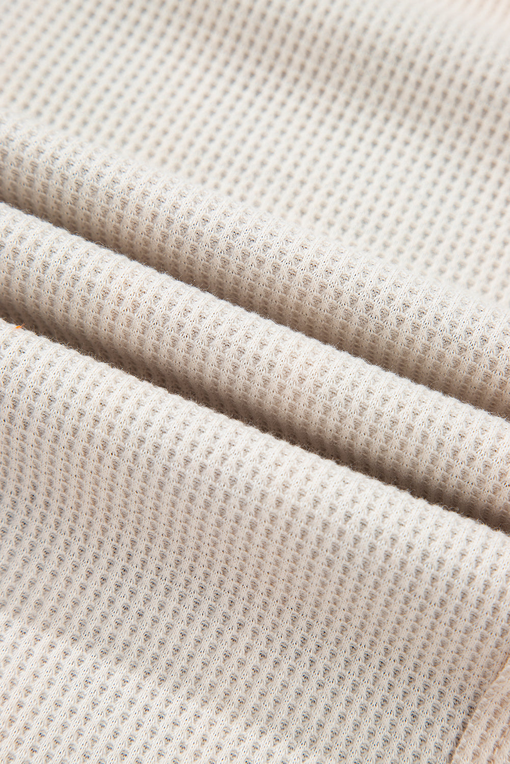 Close-up of beige textured fabric
