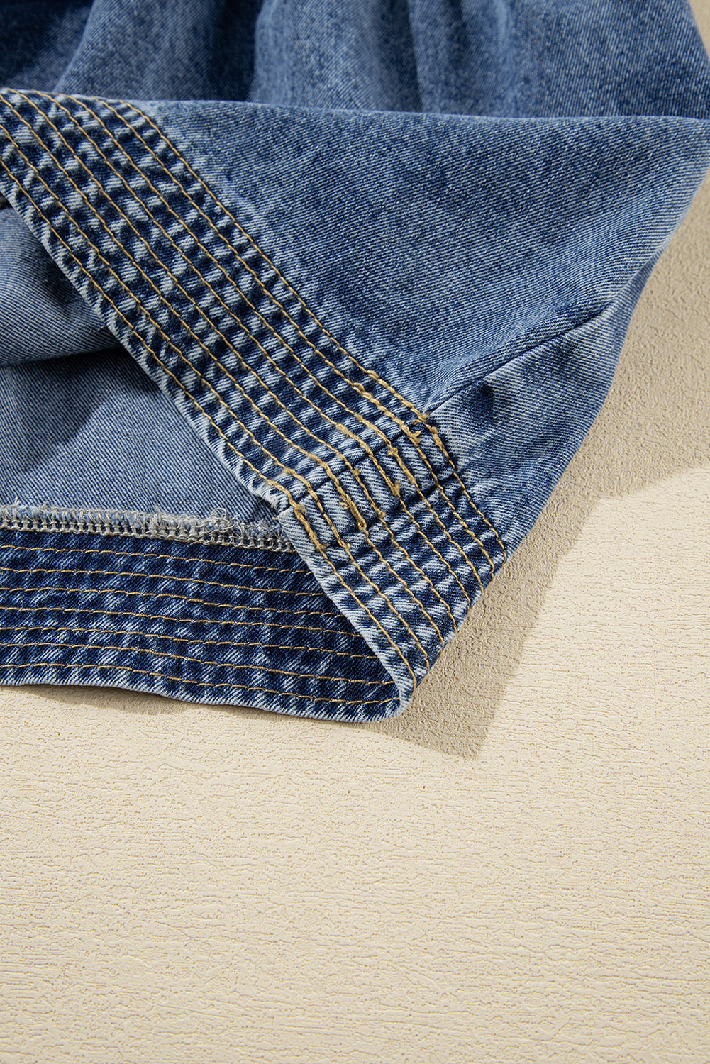 Close-up of blue denim fabric on a beige background