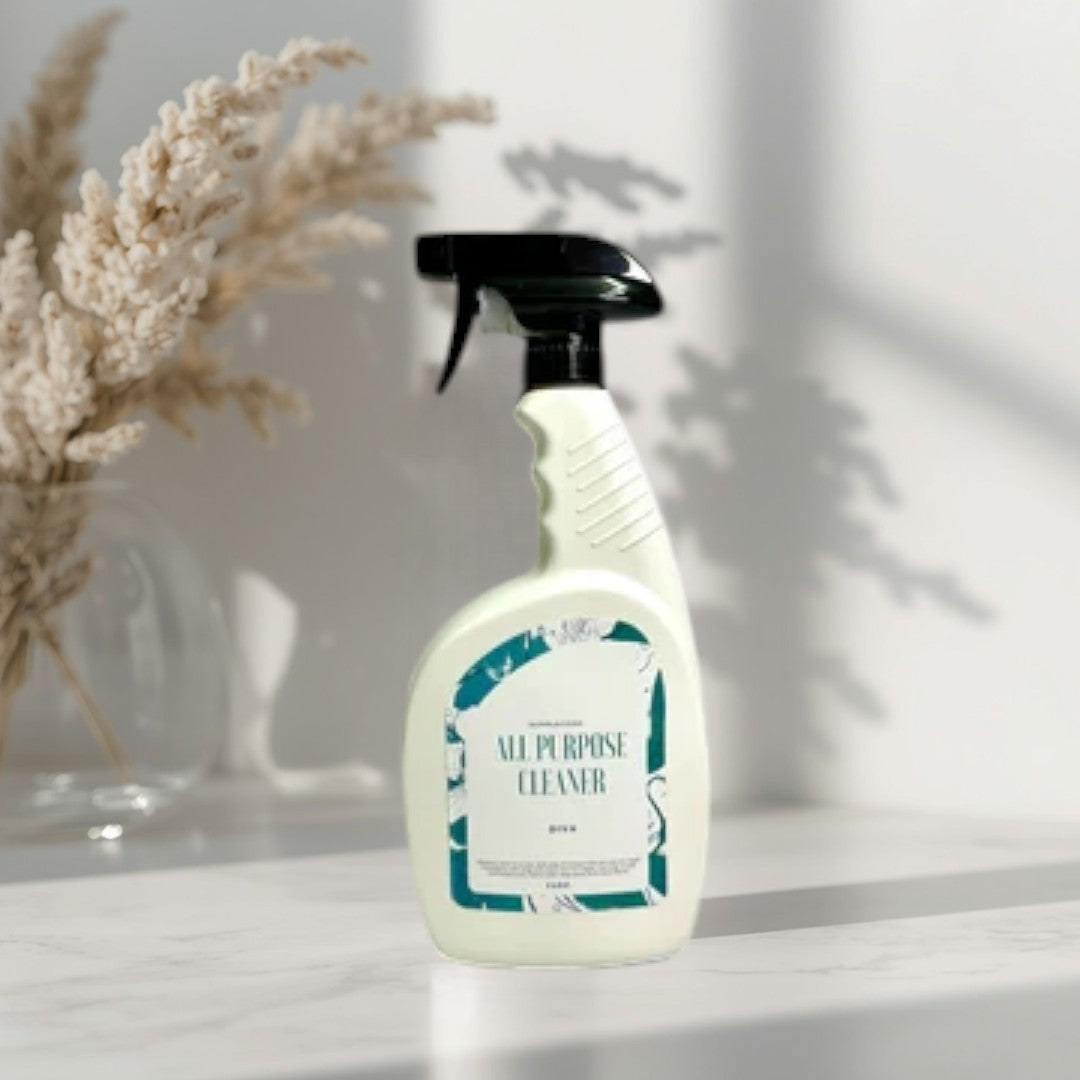 Doodlations All Purpose Cleaning Spray bottle with a teal and white label, set on a kitchen counter.