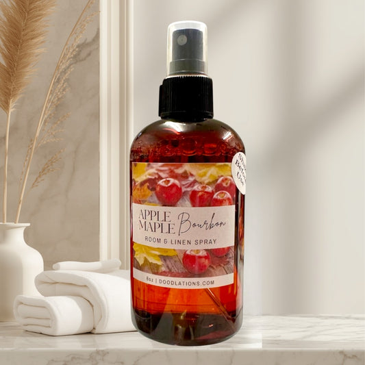 Doodlations Apples & Maple Bourbon room and linen spray bottle with a warm, autumnal label featuring apples and leaves.