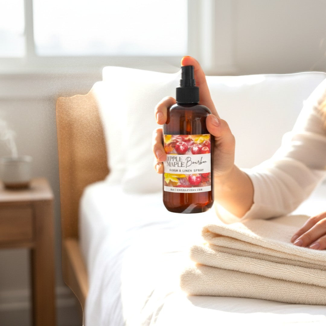 Doodlations Coffee Bar & Boutique Apples & Maple Bourbon room and linen spray bottle held over clean white towels.