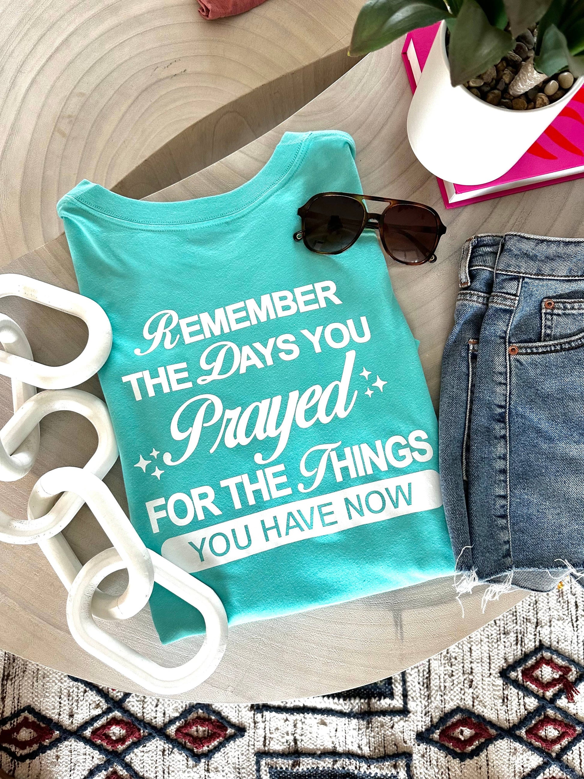 Doodlations Coffee Bar & Boutique aqua graphic tee with white text reading "Remember The Days You Prayed For The Things You Have Now".