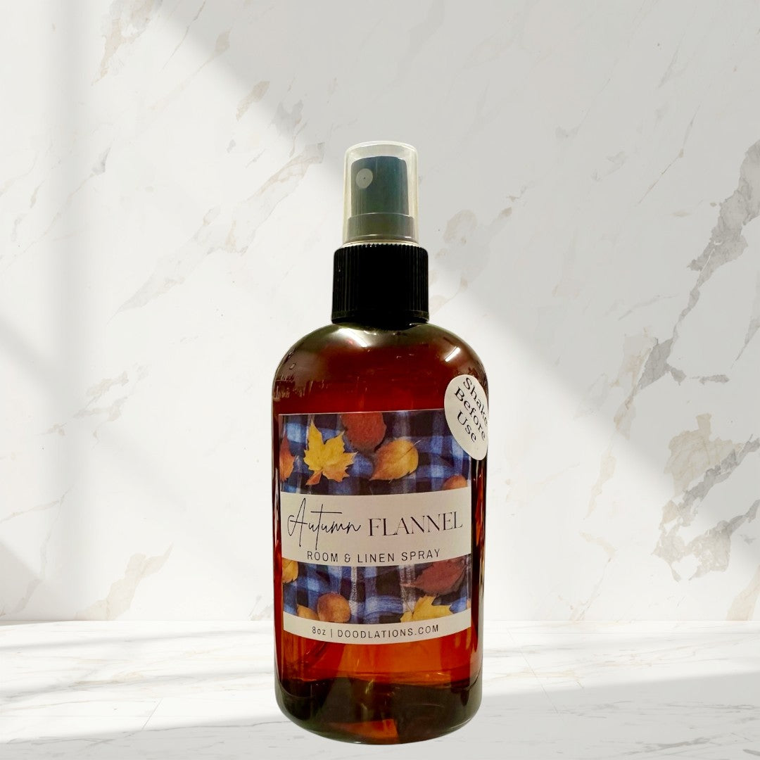 Doodlations Autumn Flannel room and linen spray in amber bottle with plaid and leaf label. Cozy fall scent.