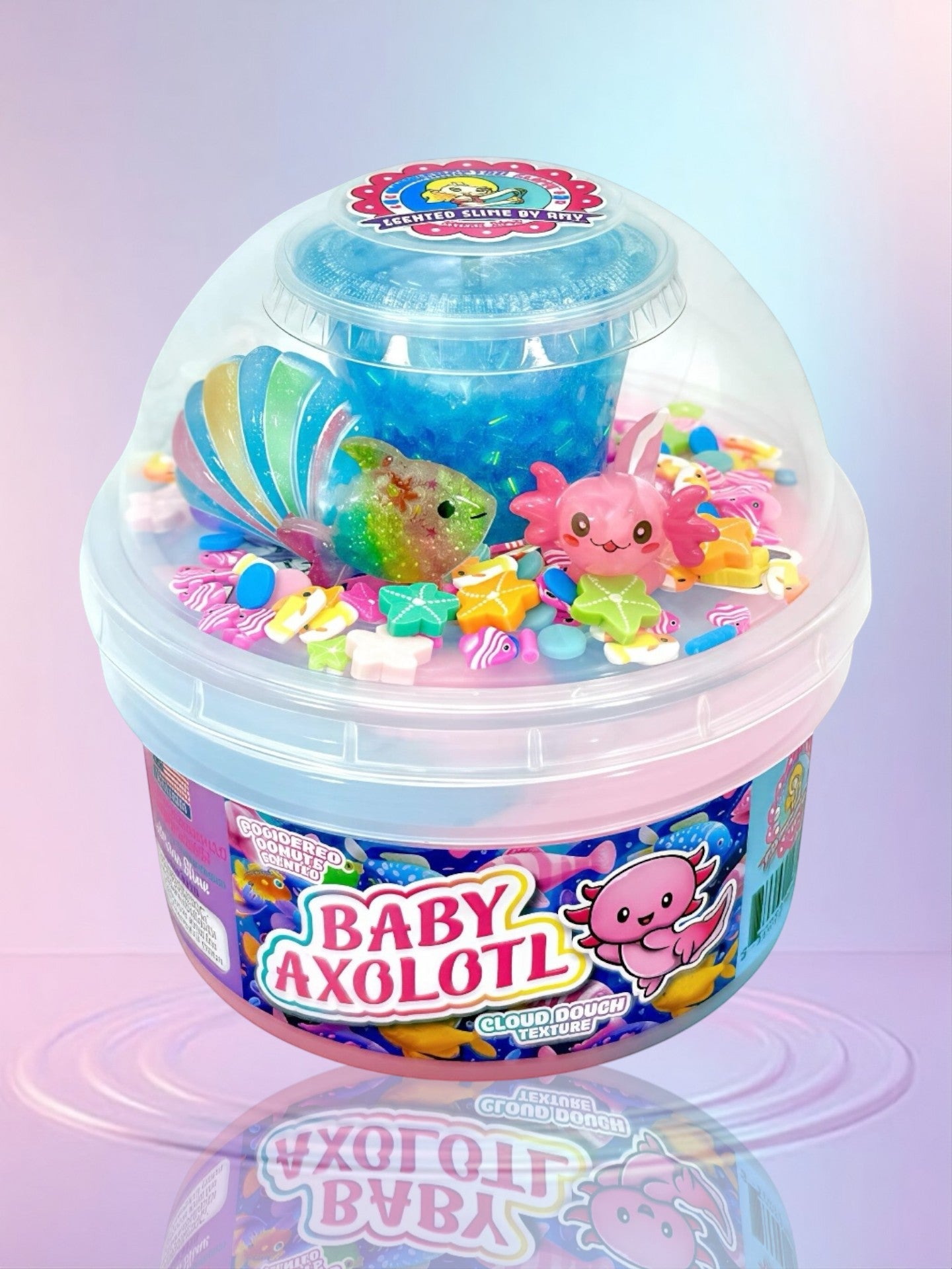 Doodlations Baby Axolotl cloud dough slime with pink and blue colors, axolotl, fish, star charms, glitter, and seashell.