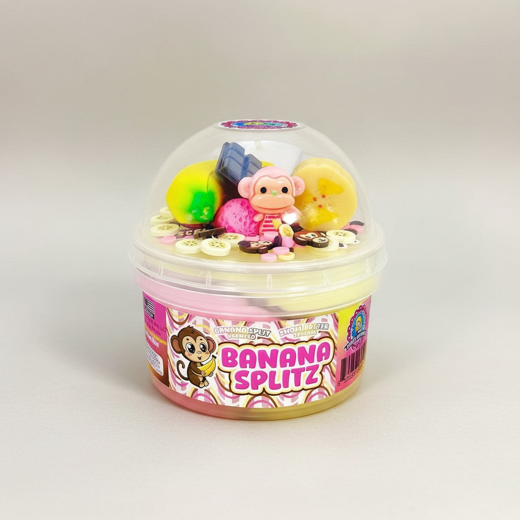 Doodlations Banana Splitz scented snow butter slime with banana, chocolate, and pink charms, plus a monkey figure.