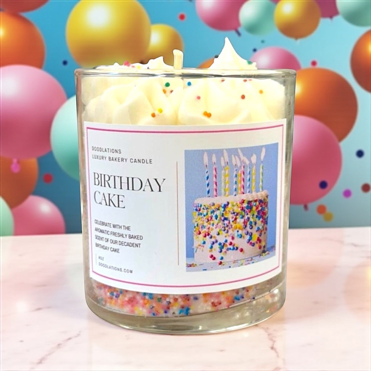 Doodlations Birthday Cake luxury bakery candle with vanilla frosting and sprinkles in a glass jar.