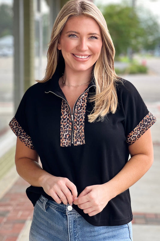 Doodlations Coffee Bar & Boutique black plus size short sleeve top with leopard print half zip and cuffs.