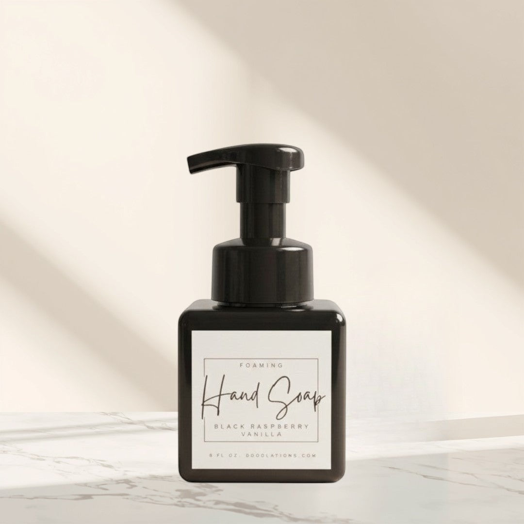 Doodlations Coffee Bar & Boutique black raspberry vanilla foaming hand soap in a square black bottle with a black pump.