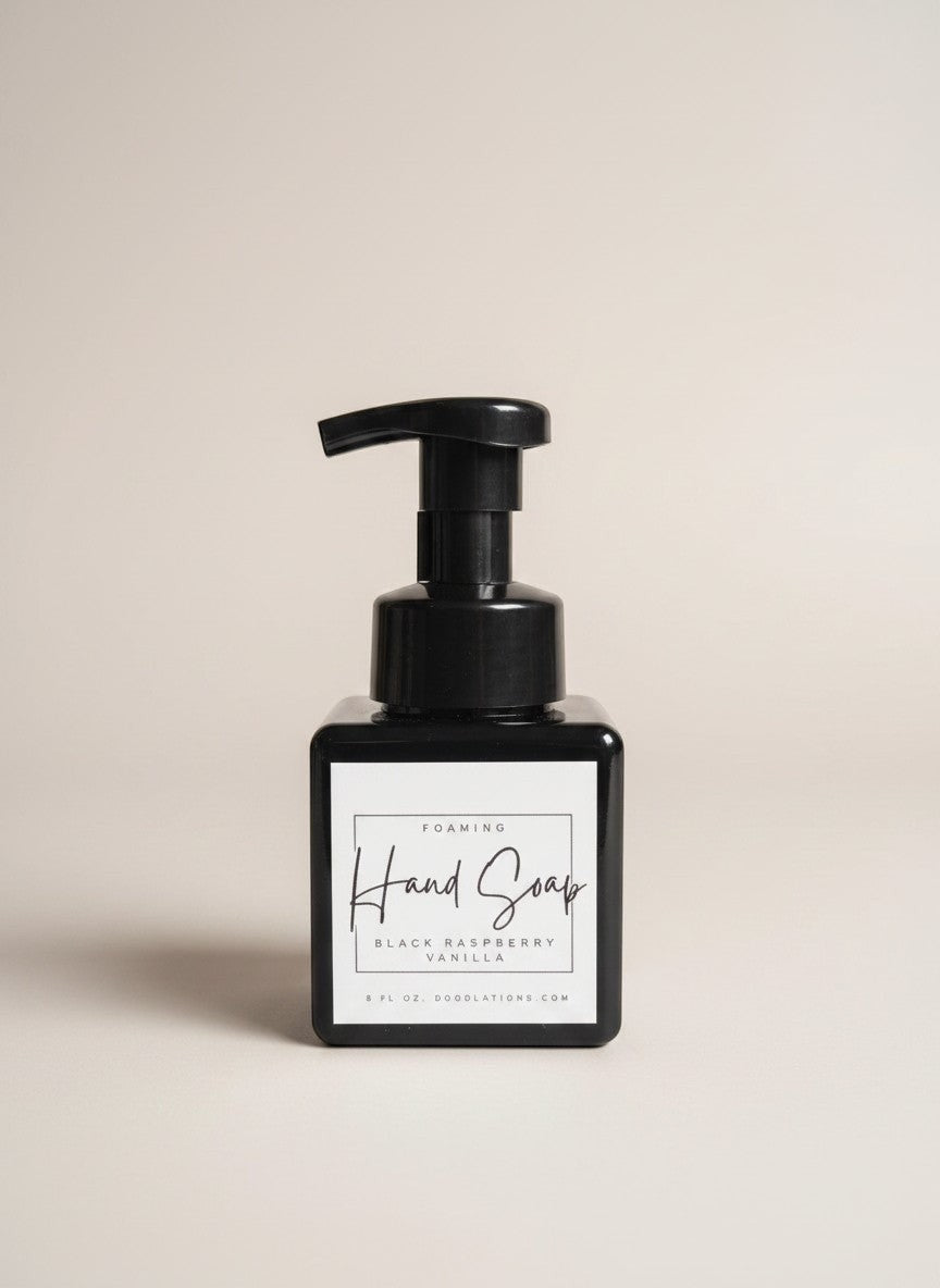 Doodlations Coffee Bar & Boutique black raspberry vanilla foaming hand soap in a square black bottle with a black pump.