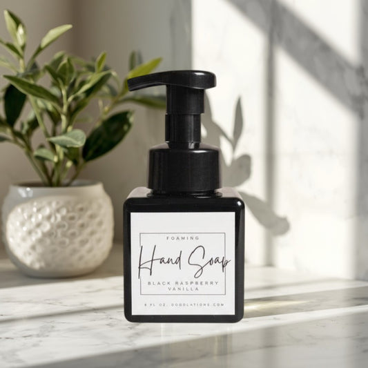 Doodlations Coffee Bar & Boutique black raspberry vanilla foaming hand soap in a square black bottle with a black pump.