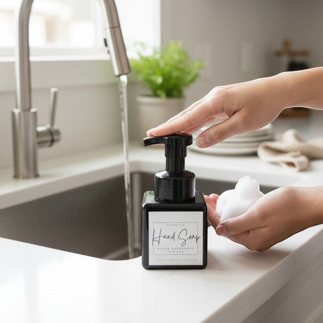 Doodlations Coffee Bar & Boutique black raspberry vanilla foaming hand soap in a square black bottle with a black pump.