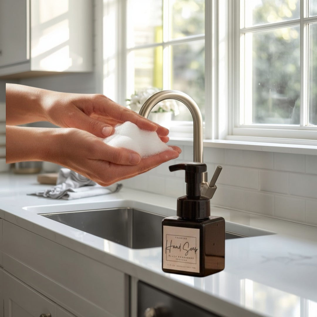 Doodlations black raspberry vanilla foaming hand soap in a square black bottle with a pump dispenser.