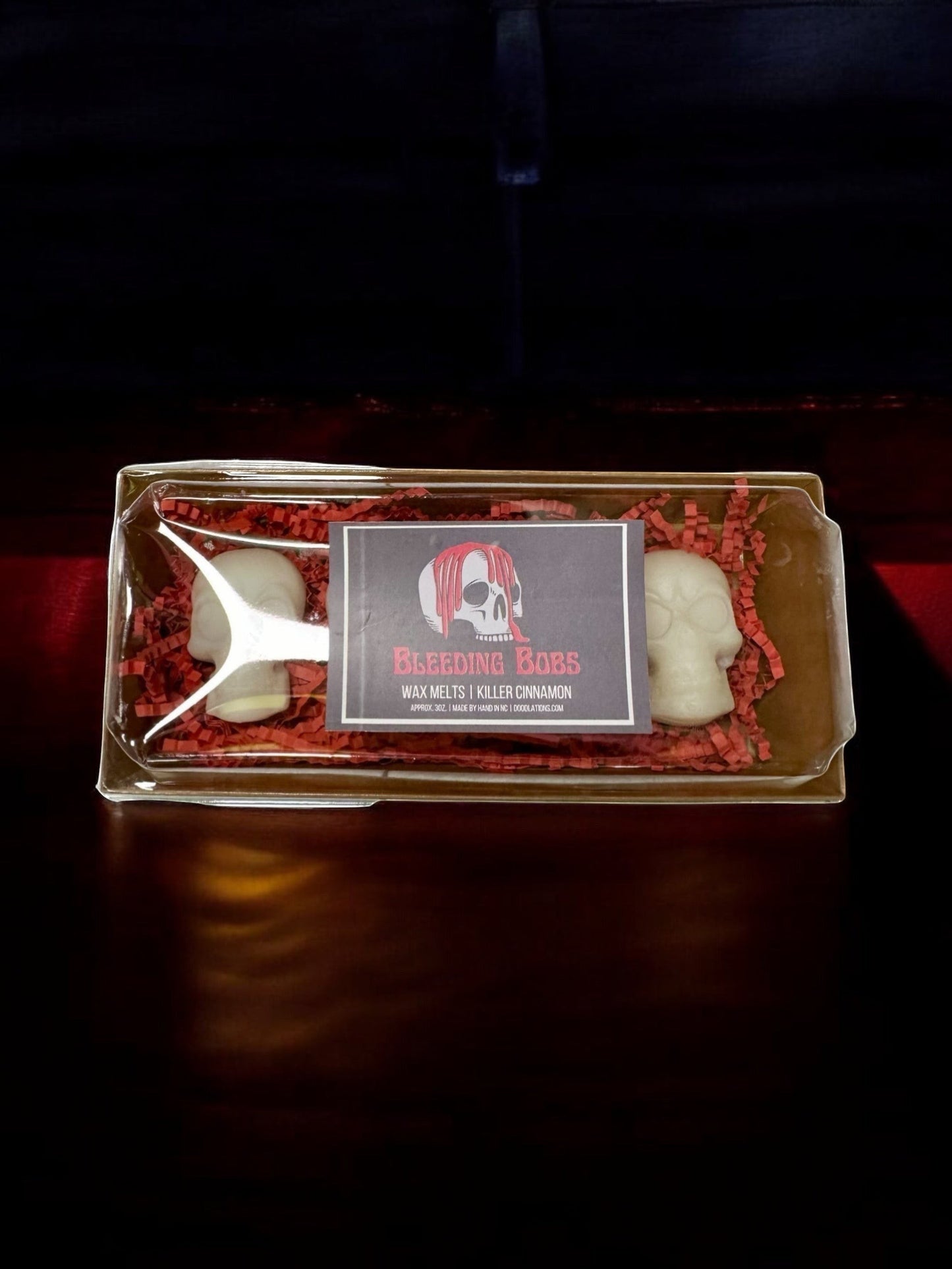 Doodlations Coffee Bar & Boutique Bleeding Bob wax melts in white skull shape with red "bleeding" effect, cinnamon scent.