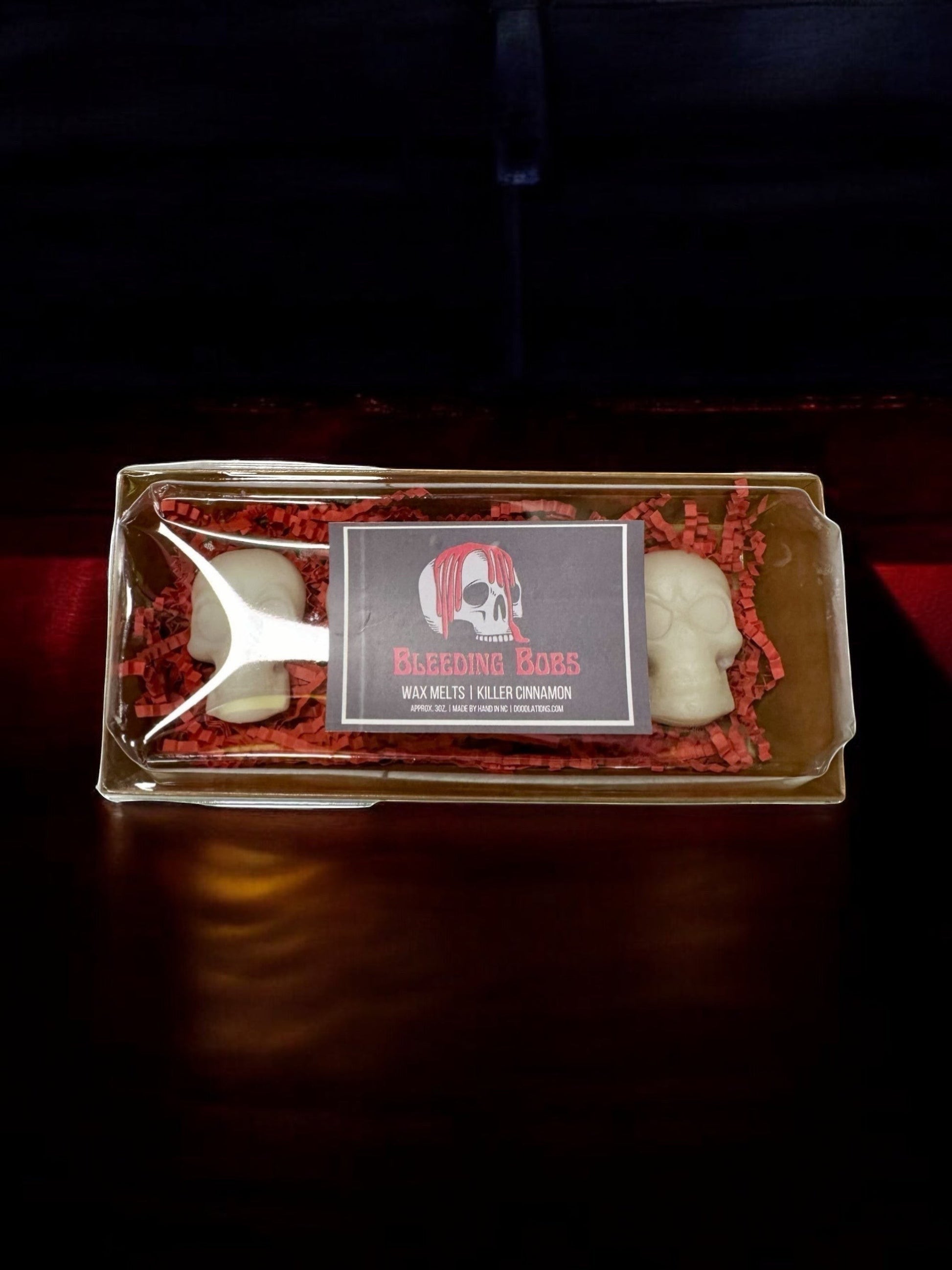 Doodlations Coffee Bar & Boutique Bleeding Bob wax melts in white skull shape with red "bleeding" effect, cinnamon scent.