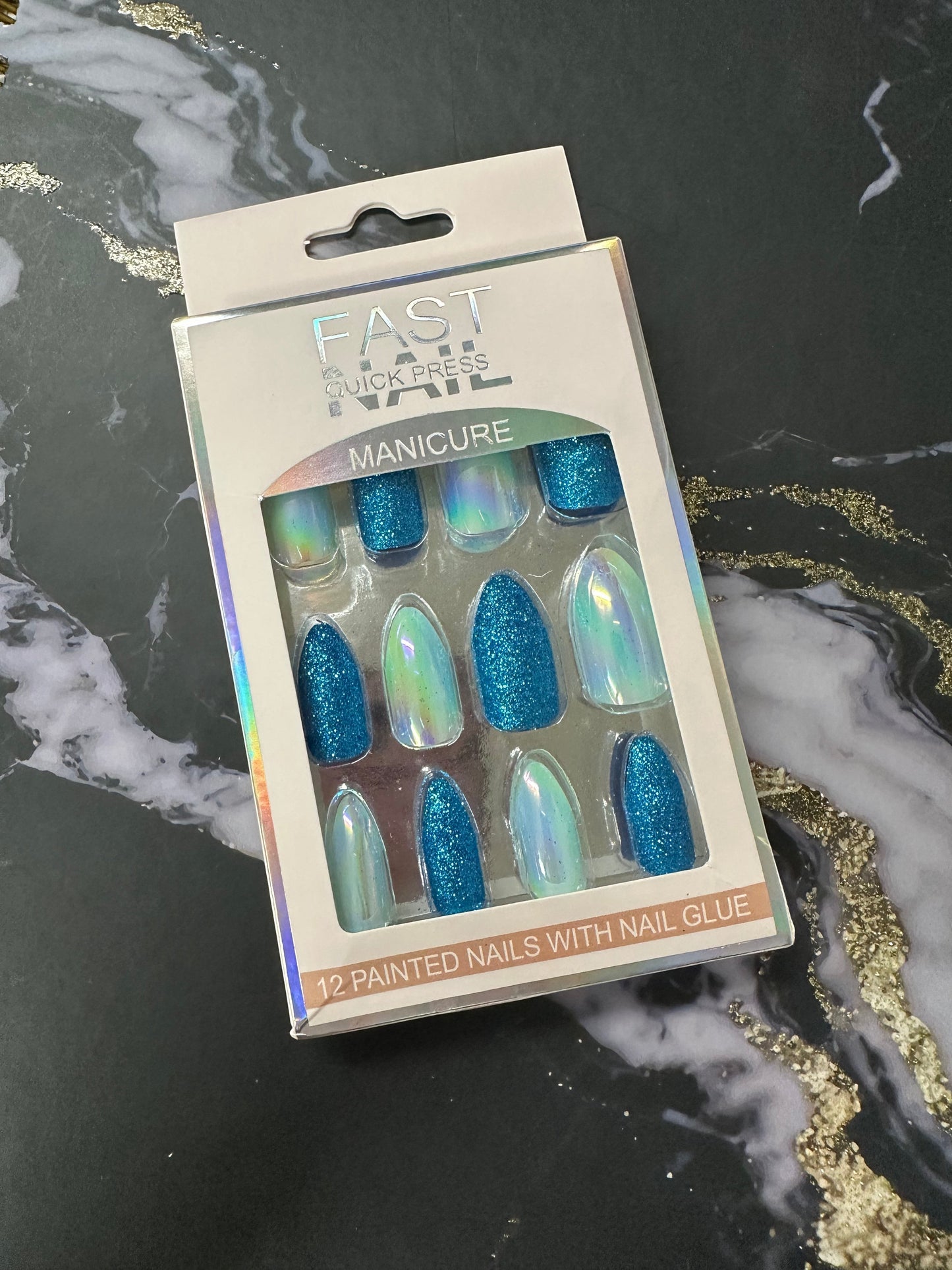Doodlations Coffee Bar & Boutique Fast Nails Quick Press Manicure set with 12 blue glitter and iridescent chrome press-on nails.