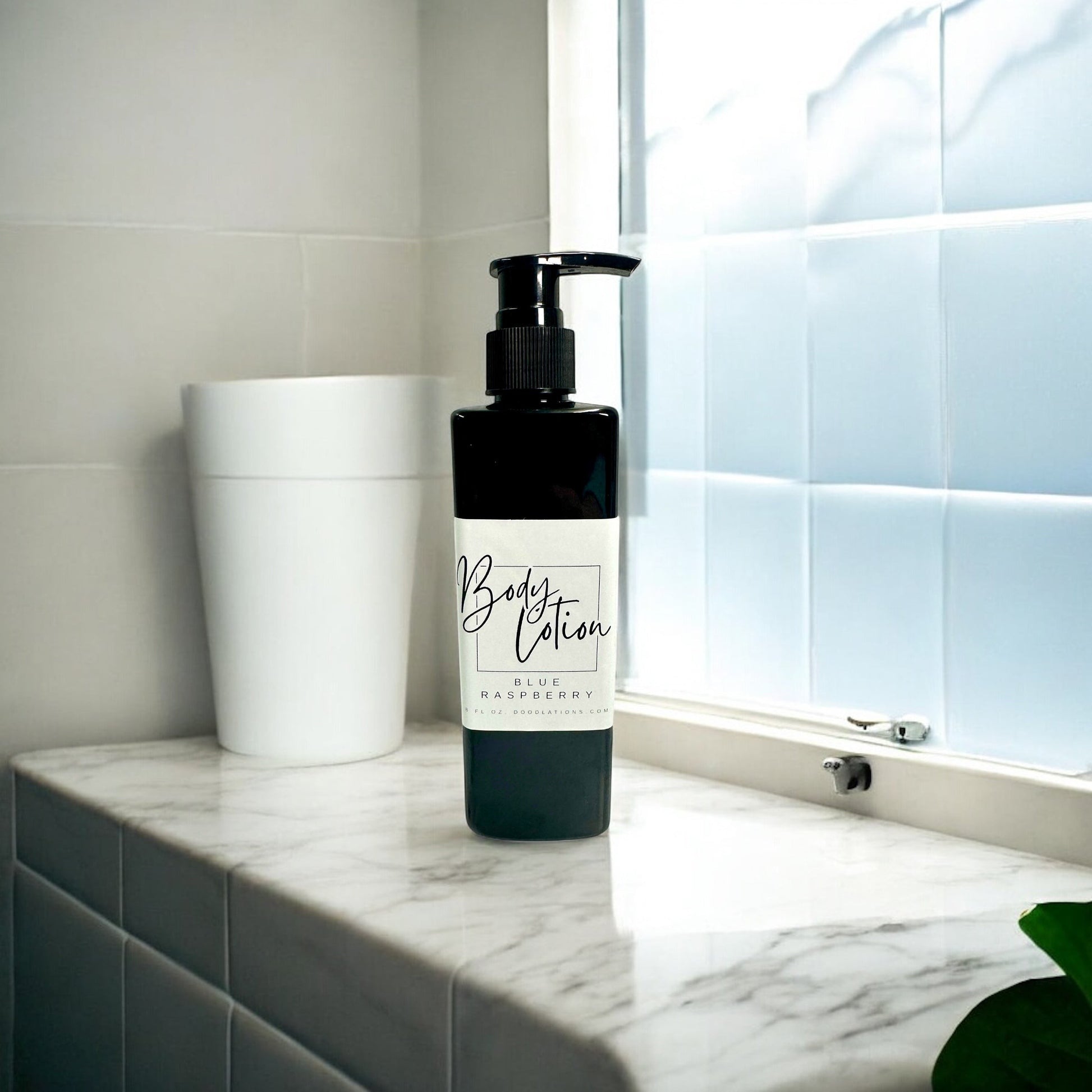 Doodlations Coffee Bar & Boutique blue raspberry body lotion in a black pump bottle, 8oz size.