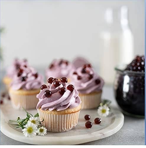 Doodlations Coffee Bar & Boutique blueberry popping boba topping cupcakes with purple frosting and small white flowers.
