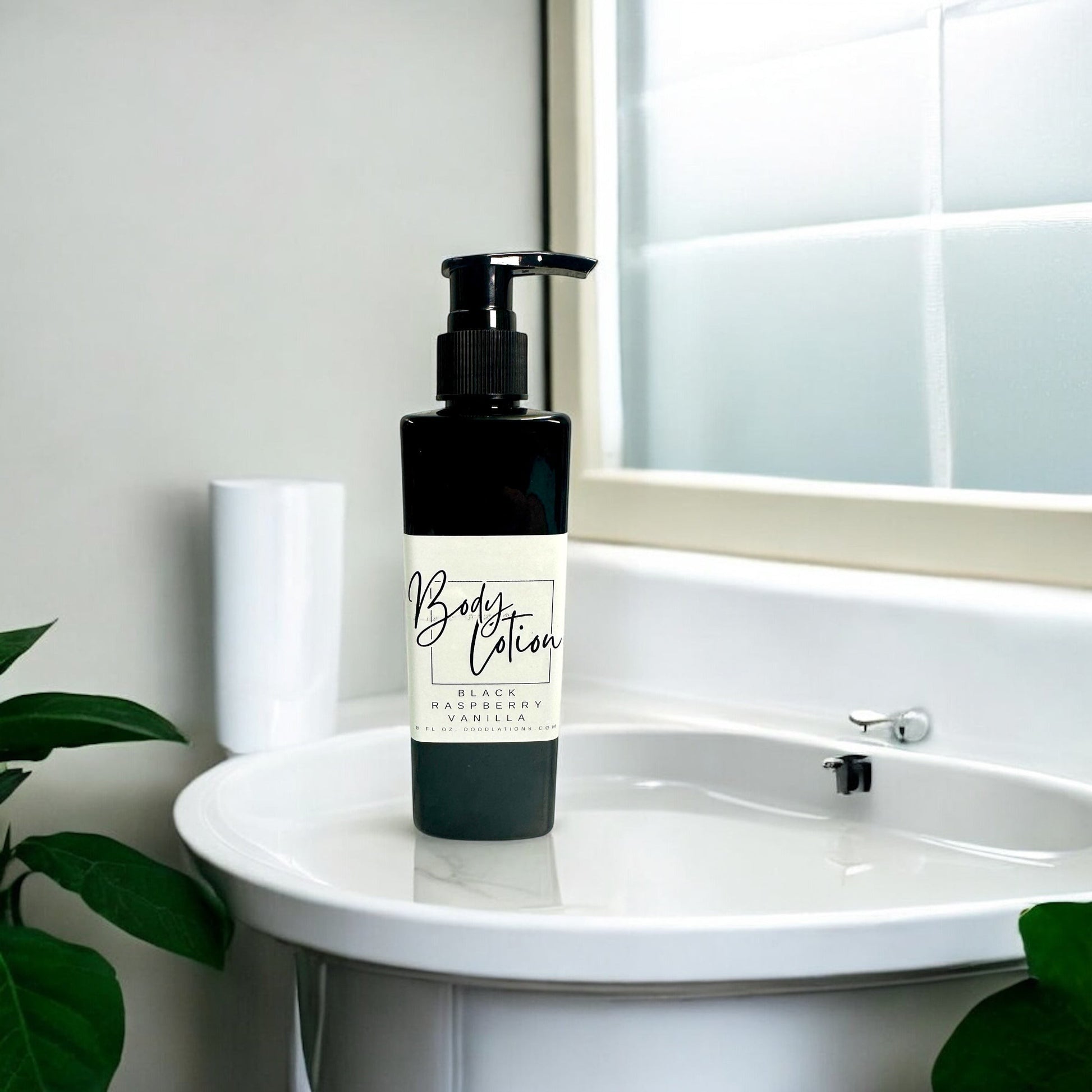 Doodlations Coffee Bar & Boutique Black Raspberry Vanilla moisturizing body lotion in an 8oz black pump bottle on a bathroom sink.