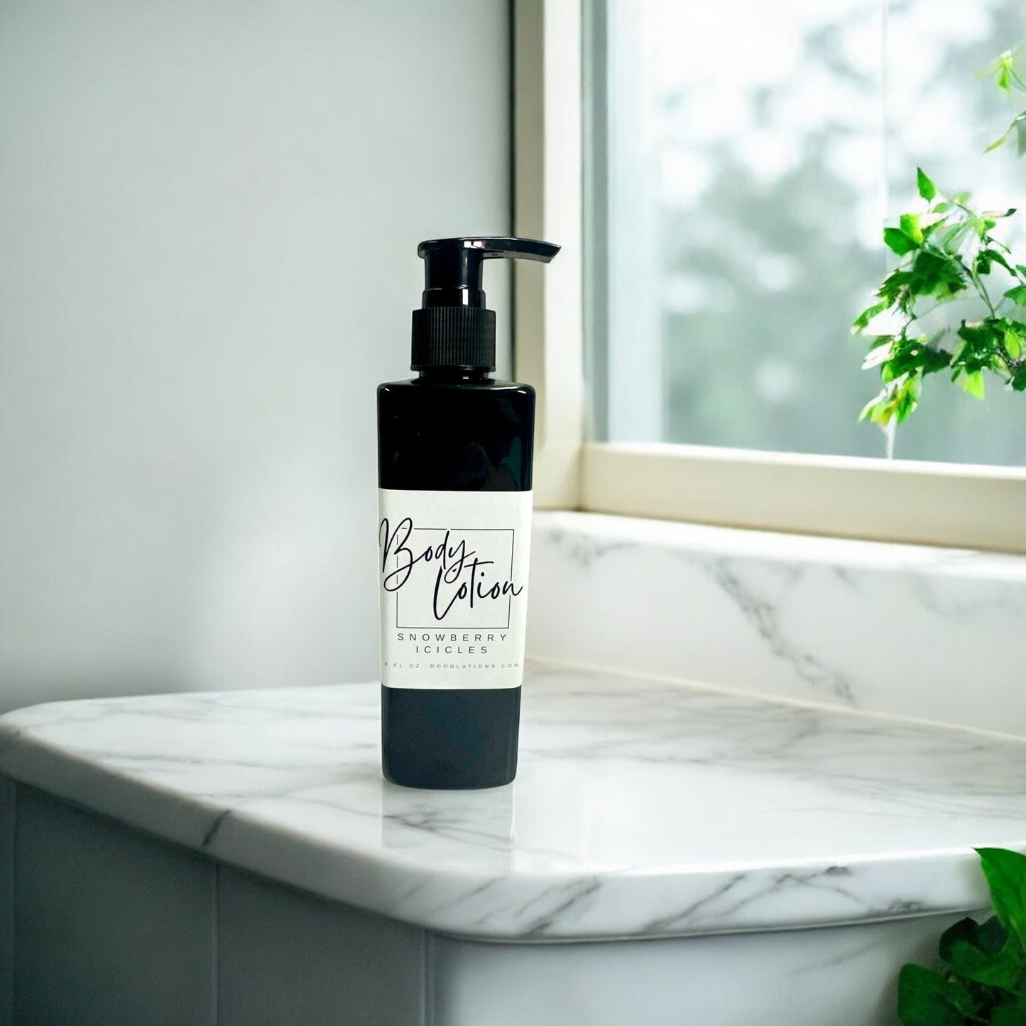 Doodlations Coffee Bar & Boutique Snowberry Icicles body lotion in a black pump bottle on a marble countertop.