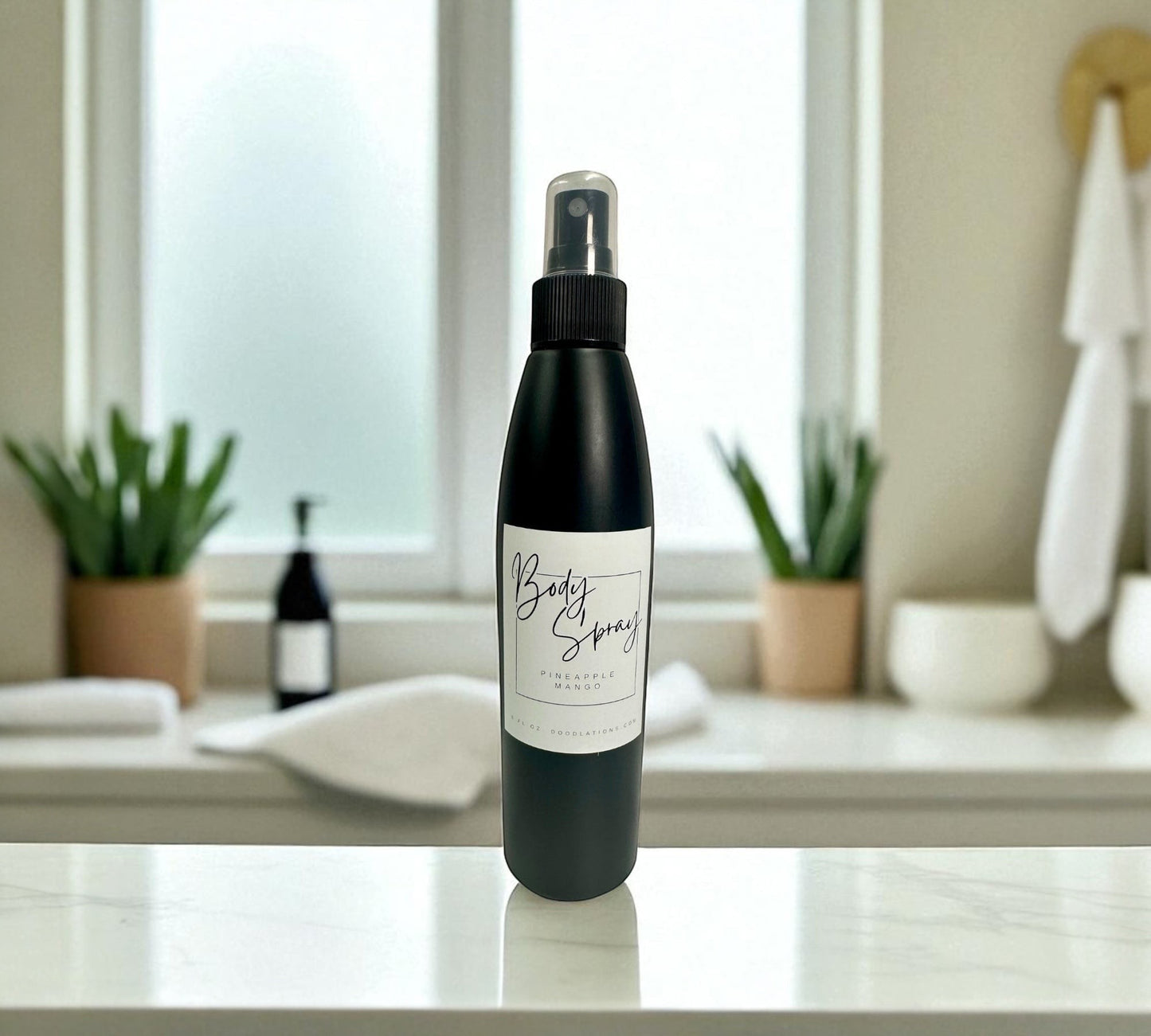 Doodlations Coffee Bar & Boutique black bottle of moisturizing body spray with pineapple mango scent.