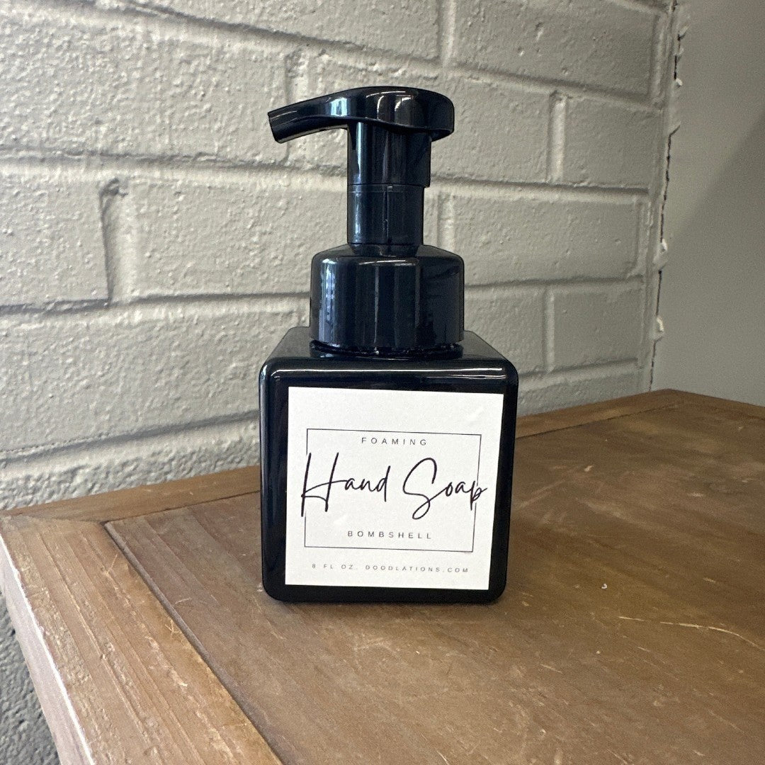 Doodlations Bombshell foaming hand soap in a black square bottle with a white label.